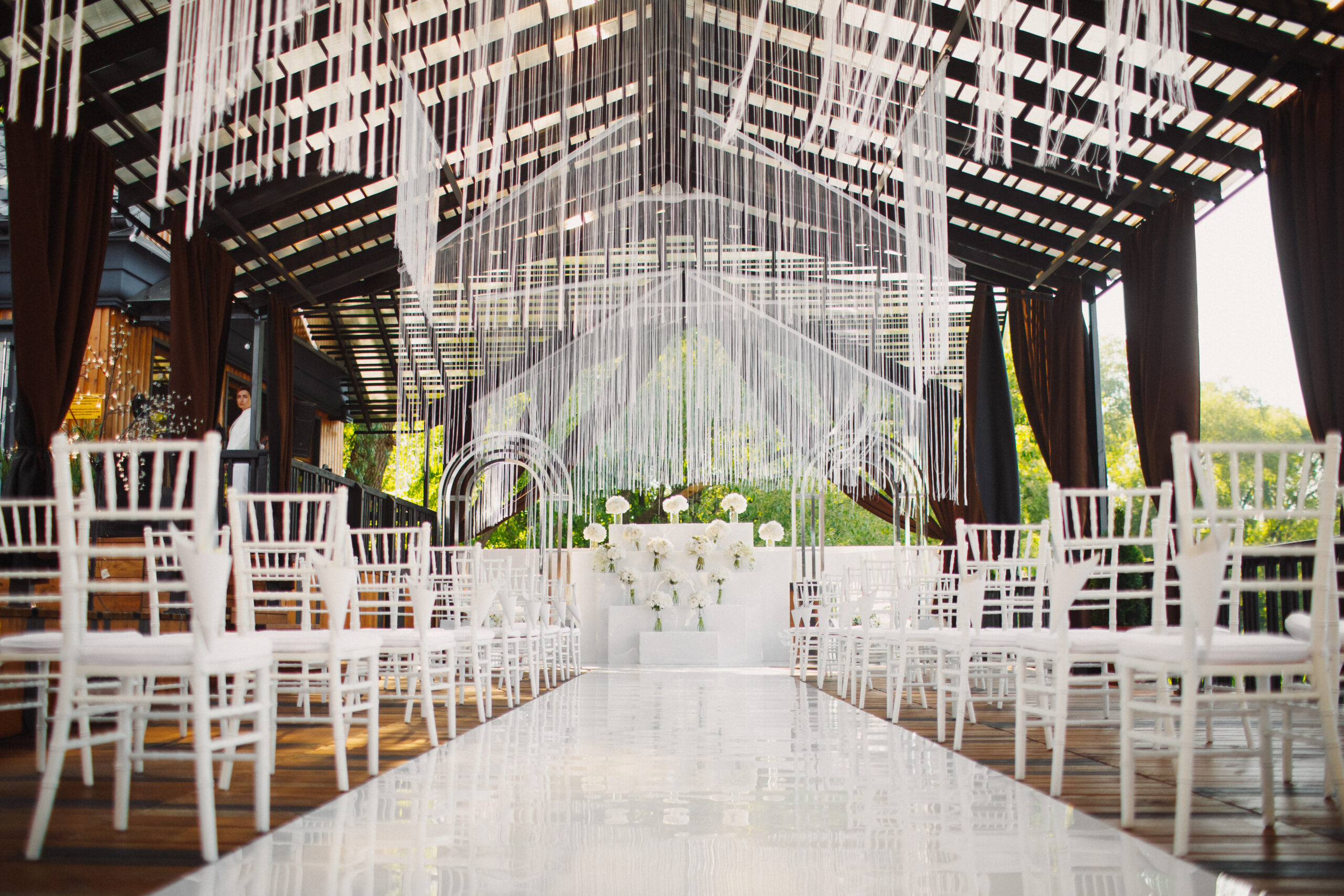 decorated venue for the wedding ceremony  with festoons and white flowers
