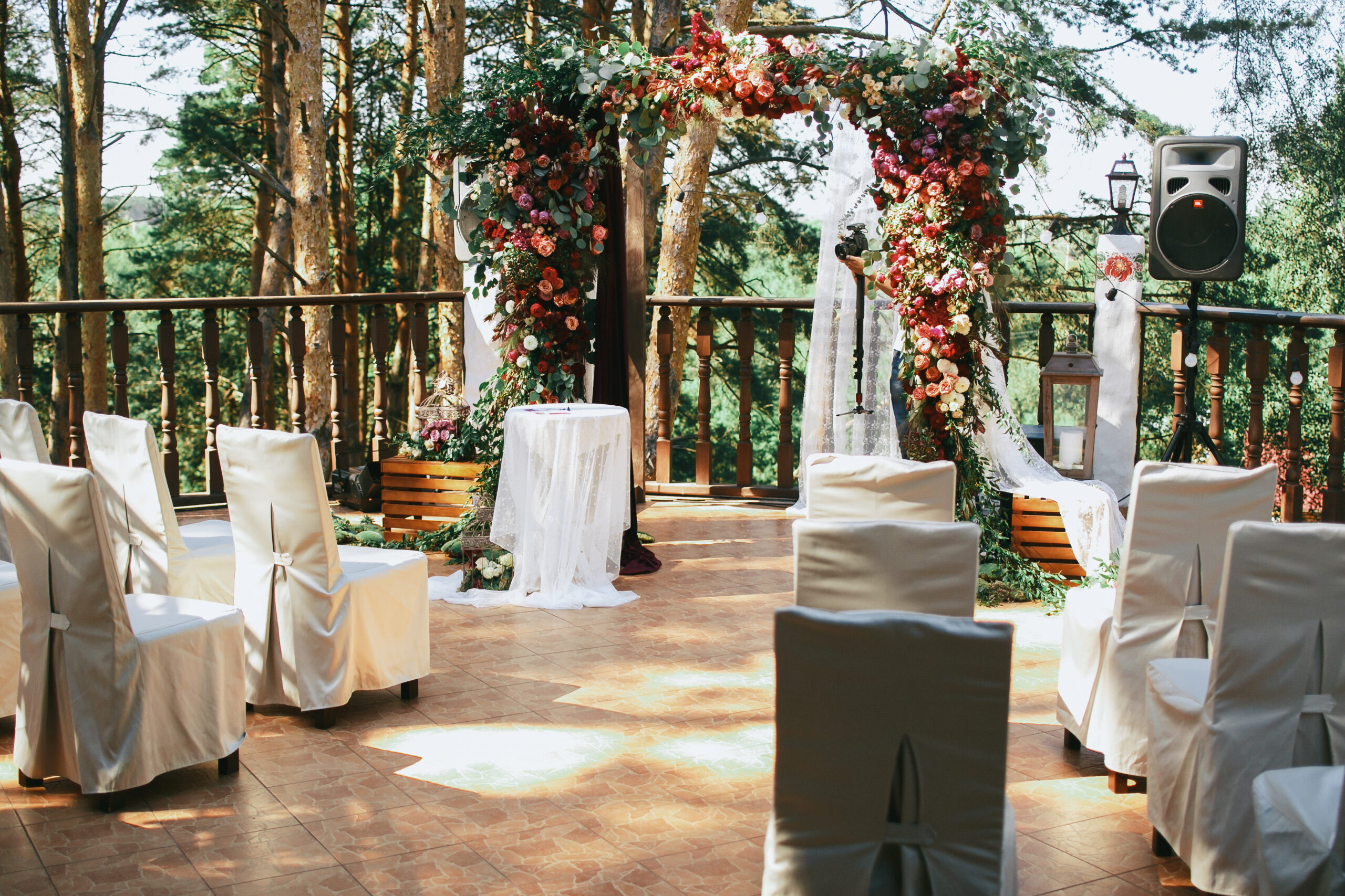 White chairs stand before wedding altar on the porch White chairs stand before wedding altar on the porch
