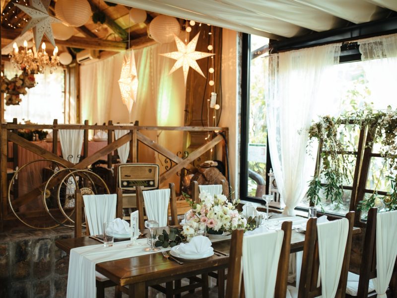 Table setting with floral centerpiece at wedding reception venue.