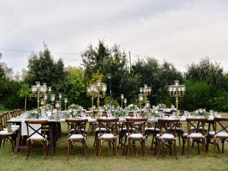 Decorated wedding celebration table with guests seats outdoors i Decorated wedding celebration table with guests seats outdoors in the gardens