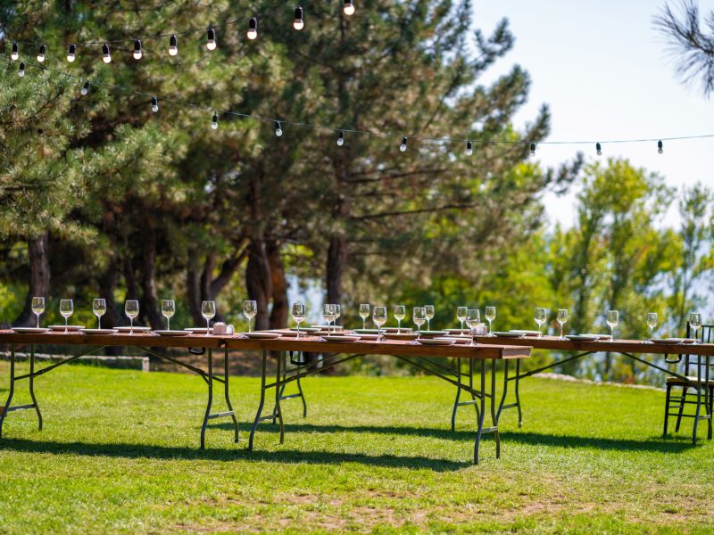 Preparing for an open-air party. Decorated served tables await guests. Decoration Details Preparing for an open-air party. Decorated served tables await guests. Decoration Details.