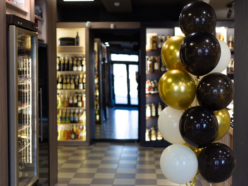 The alcohol store is decorated with balloons on the occasion of the opening. Alcohol shop opening