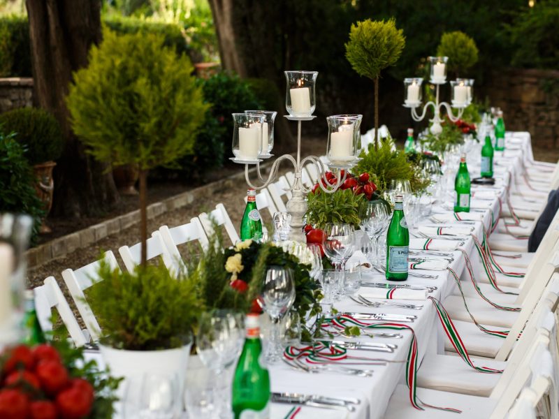 Festive dinner table decorated in white and green tones Festive dinner table decorated in white and green tones